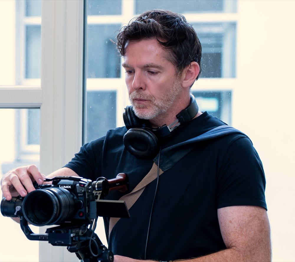 Conor Donelan adjusting a Lumix GH7 camera on a gimbal rig